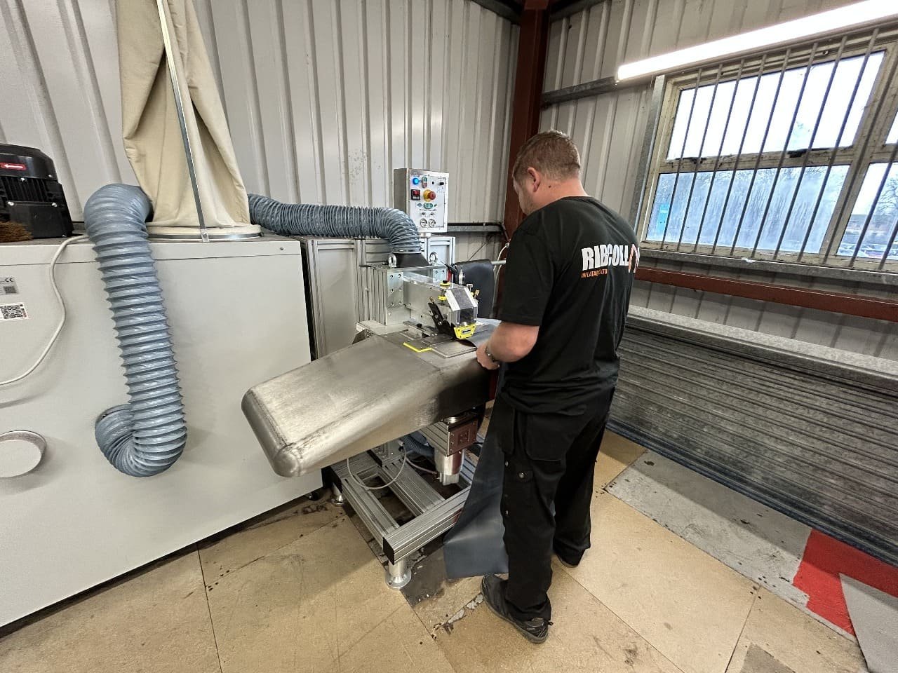 Ribcollar Technician using bespoke Hypalon Sanding Machine