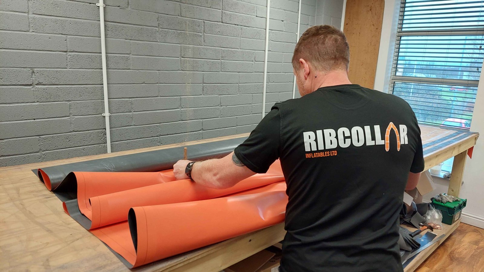 Ribcollar workshop with a rigid inflatable boat being retubed in Orca Hypalon