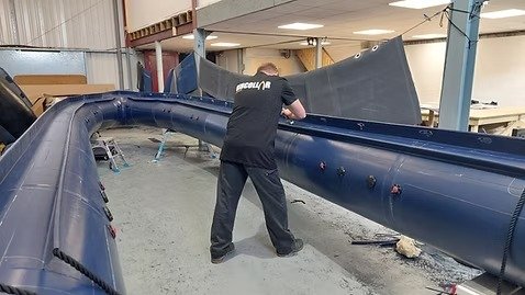 Slide-on RIB tube system, showing a tube retained mechanically so it can be removed from the hull